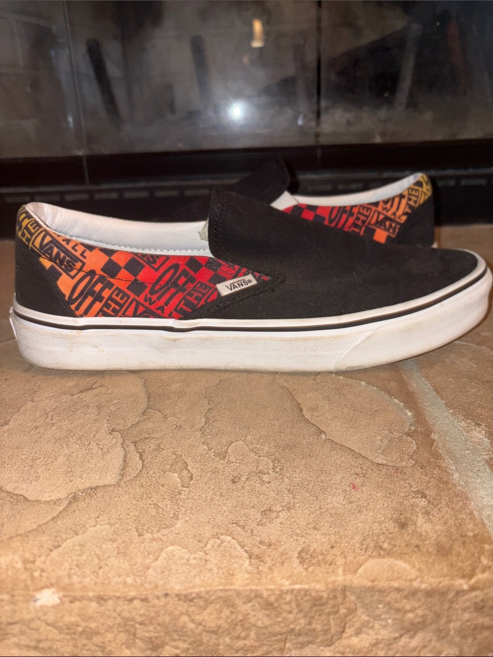 Vans Black Slip-On Sneakers with Red and Orange Graphic Panels